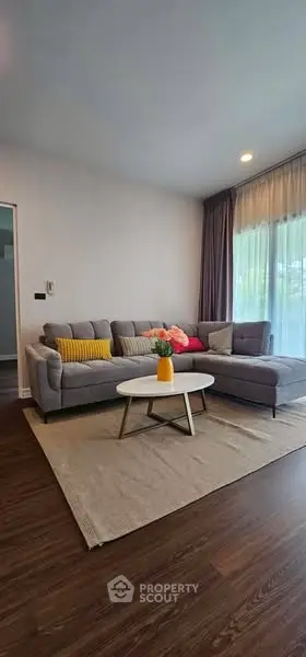 Stylish living room with modern gray sectional sofa and vibrant decor accents.