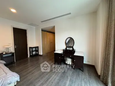 Spacious bedroom with elegant wooden furniture and ample natural light