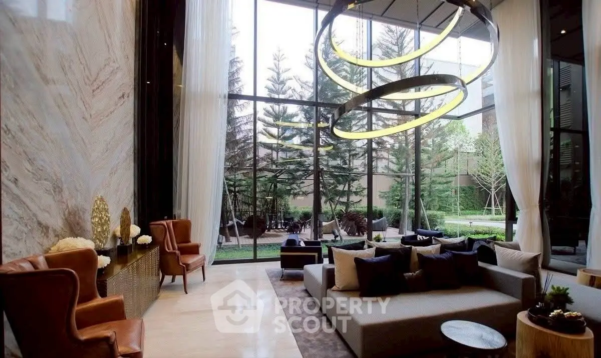 Luxurious living room with high ceilings and modern decor overlooking a lush garden.