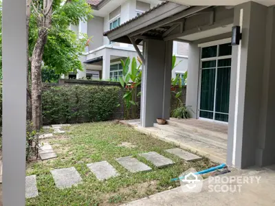 Charming garden view of modern home with lush greenery and spacious patio area.