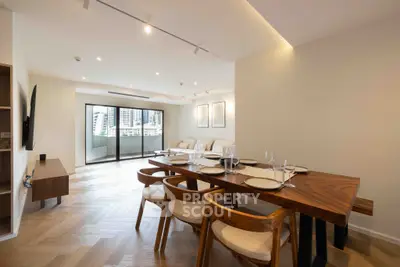 Spacious modern living room with elegant dining area and city view balcony.