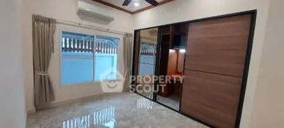 Spacious bedroom with built-in wardrobe and large window