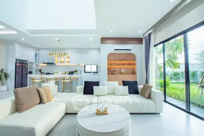 Luxurious open-plan living room with modern kitchen and garden view