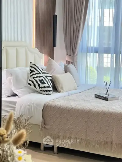 Luxurious bedroom with elegant decor and large window for natural light