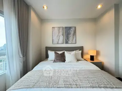 Cozy bedroom with modern decor and city view, perfect for urban living.