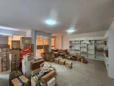 Spacious storage room with boxes and shelves, ideal for organizing inventory.
