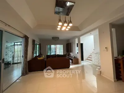 Spacious living room with modern lighting and large windows in a luxurious home