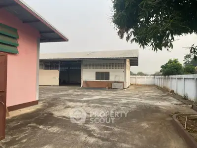 Spacious industrial property with large outdoor area and secure fencing, ideal for commercial use.