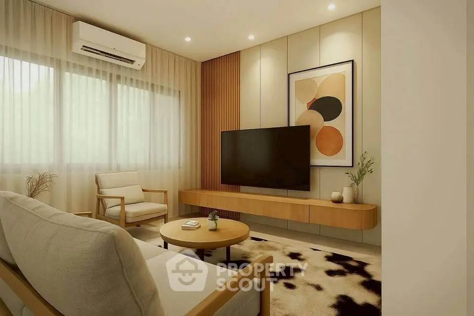 Modern living room with stylish decor and large TV, featuring cozy seating and elegant artwork.
