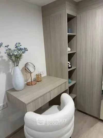 Stylish modern study nook with built-in shelves and elegant decor in a cozy apartment.