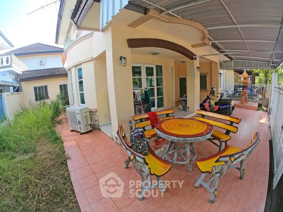Charming outdoor patio with unique round table and benches in a suburban home