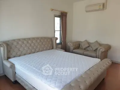 Luxurious bedroom with elegant tufted furniture and ample natural light