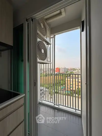 Modern apartment balcony with city view and air conditioning units