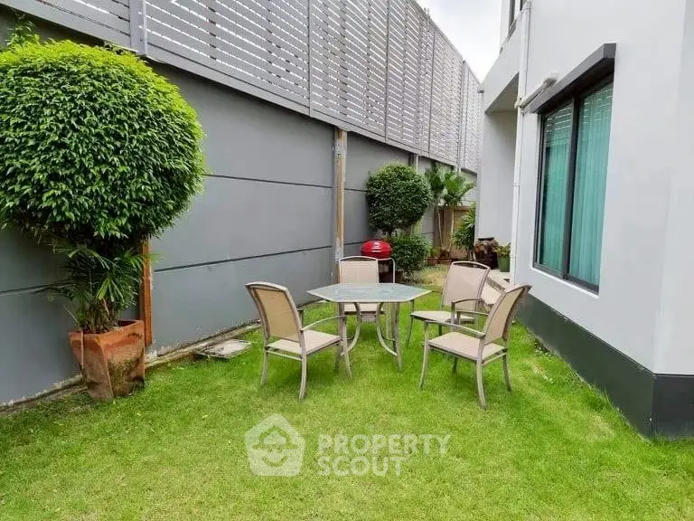 Charming garden area with outdoor seating and lush greenery, perfect for relaxation and entertaining.