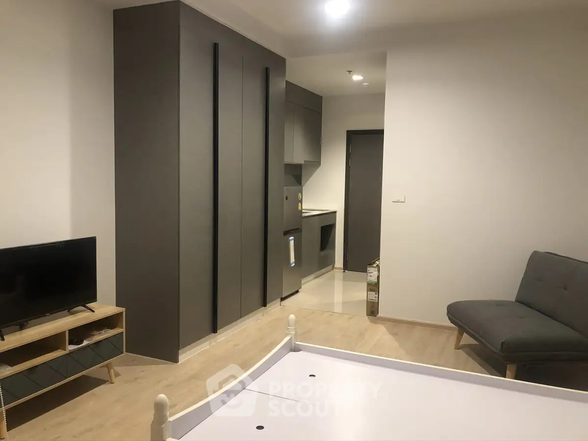 Modern studio apartment with sleek kitchen and cozy living area