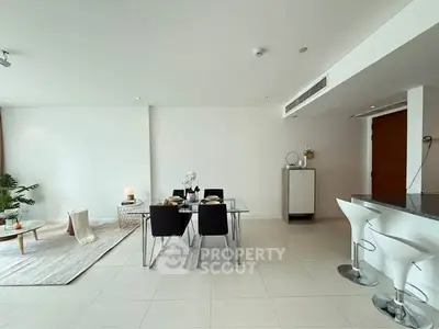 Spacious modern living room with dining area and sleek kitchen bar, perfect for entertaining.