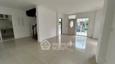 Spacious open-plan living area with tiled flooring and ample natural light, perfect for modern living.
