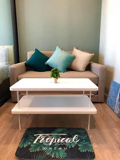 Cozy living room with modern sofa and tropical decor accents