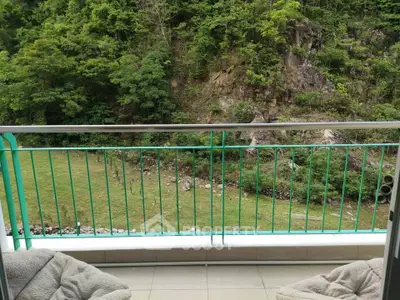 Scenic balcony view overlooking lush greenery and rocky landscape, perfect for nature lovers.
