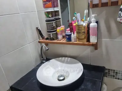 Modern bathroom sink with stylish countertop and organized toiletries