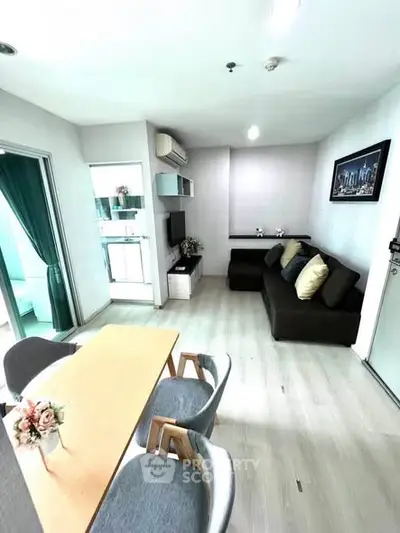 Modern living room with dining area, featuring sleek furniture and stylish decor in a bright, open space.