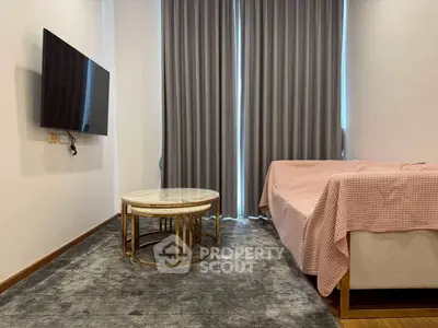 Cozy living room with modern TV setup and elegant curtains