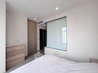 Modern bedroom with large window and minimalist design