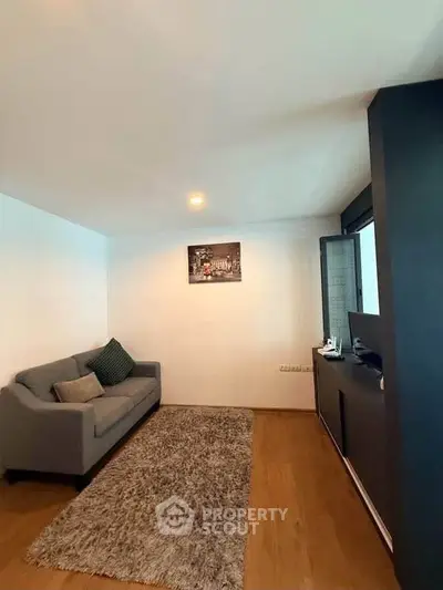 Cozy living room with modern sofa and stylish decor in a contemporary apartment.