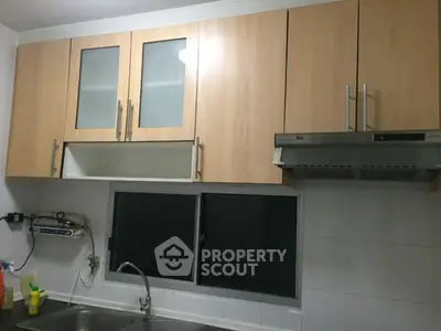 Modern kitchen with sleek cabinets and stainless steel range hood