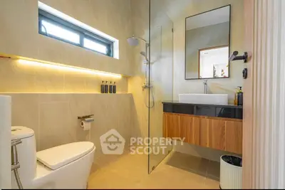 Modern bathroom with sleek design, glass shower, and elegant fixtures in a contemporary home.