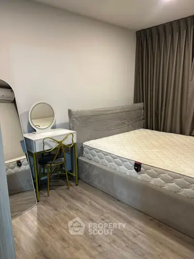 Cozy bedroom with modern furnishings and elegant decor, featuring a comfortable bed and stylish vanity.