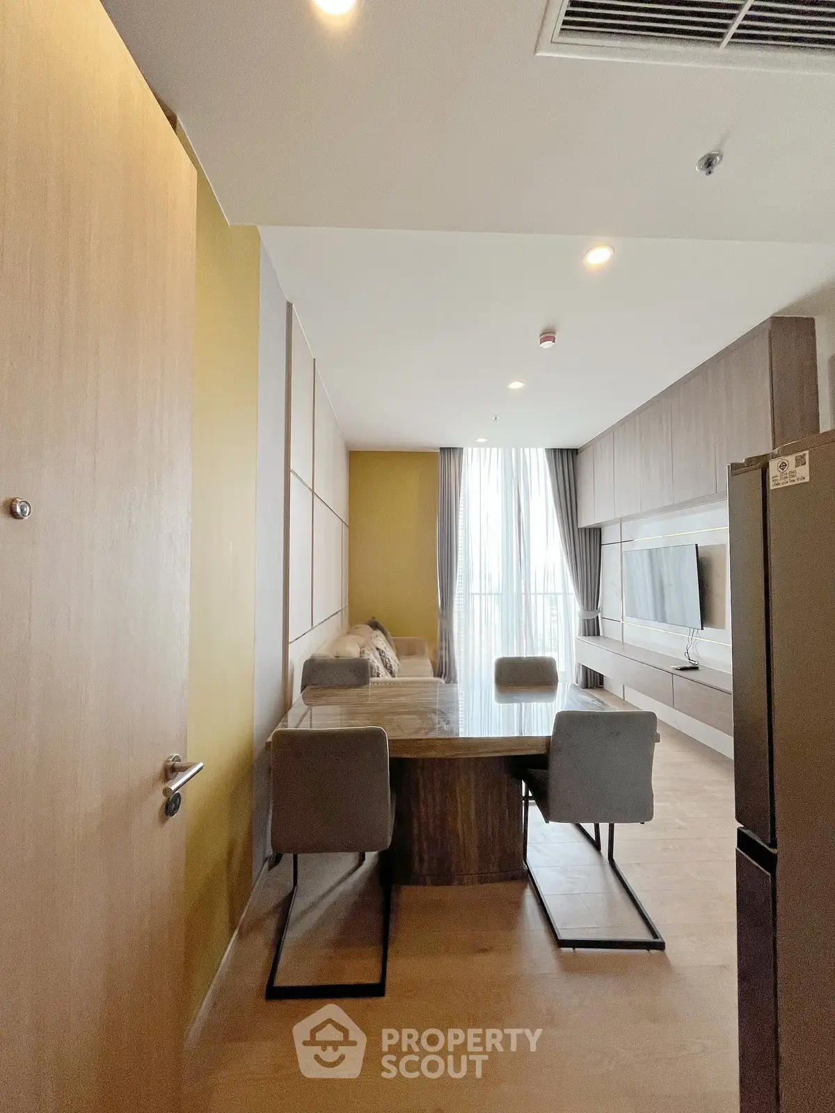 Modern living room with dining area and stylish decor in a contemporary apartment.