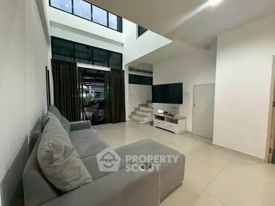 Spacious modern living room with high ceilings and large windows