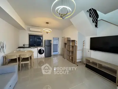 Modern open-plan living room with sleek kitchen and stylish lighting