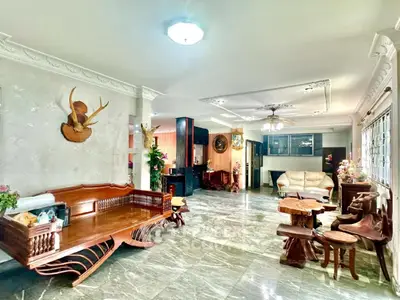 Spacious living room with elegant marble flooring and unique wooden furniture