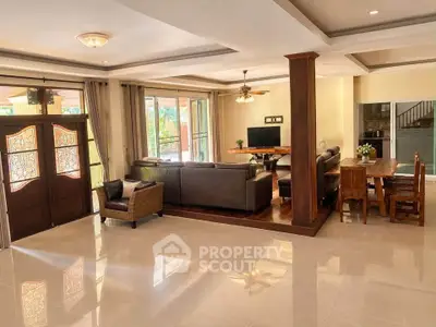 Spacious open-plan living room with elegant decor and abundant natural light.