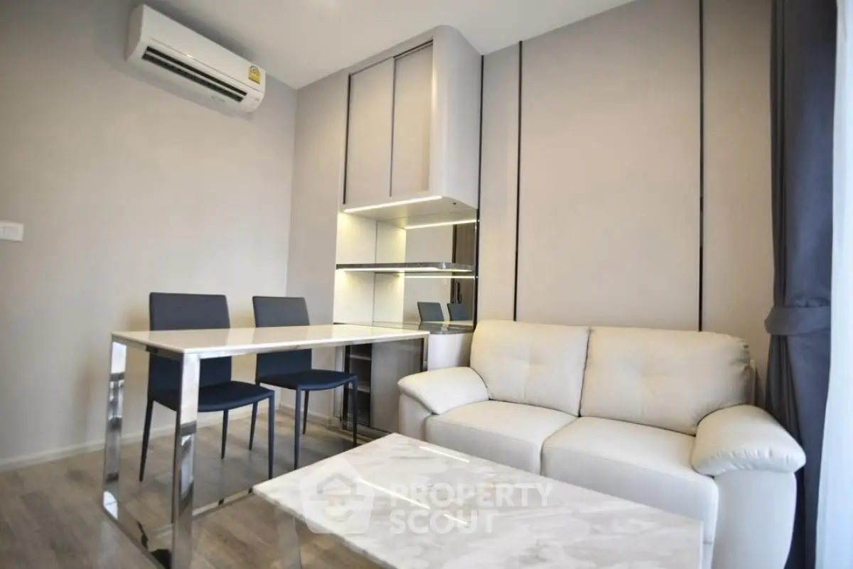 Modern living room with sleek furniture and air conditioning, perfect for urban living.