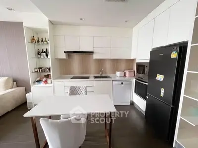 Modern kitchen with sleek white cabinetry and integrated appliances