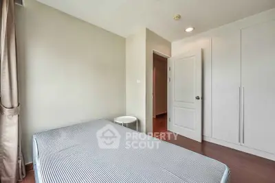 Spacious bedroom with minimalist design and ample natural light