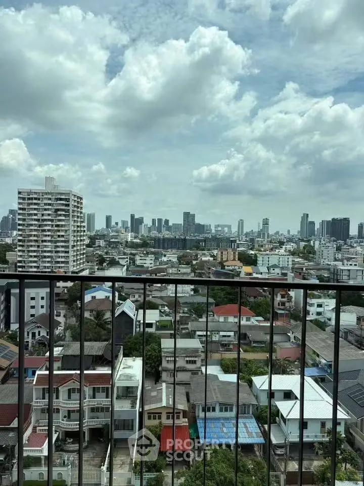 Stunning cityscape view from a high-rise balcony showcasing urban skyline and residential area.