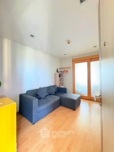 Cozy living room with modern sofa and wooden flooring