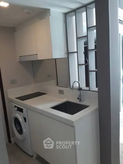 Modern compact kitchen with washing machine and sleek design