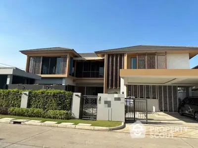 Modern two-story house with stylish facade and spacious driveway in a serene neighborhood.