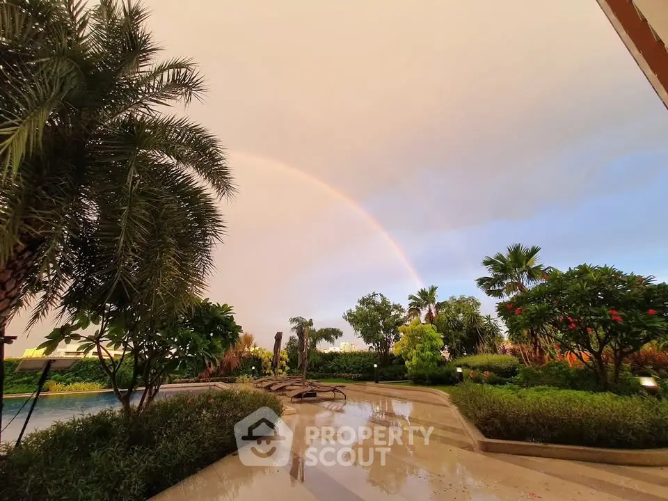 Luxurious garden view with pool and rainbow in upscale real estate property