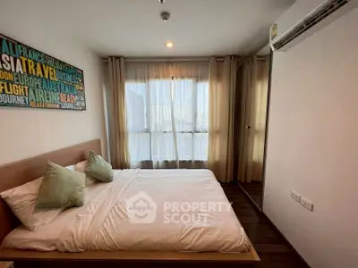 Modern bedroom with large window and stylish decor in a cozy apartment.