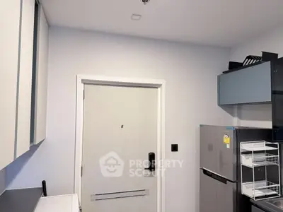 Modern kitchen with sleek cabinets and stainless steel fridge