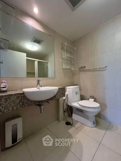 Modern bathroom with sleek fixtures and granite countertop in a contemporary home.