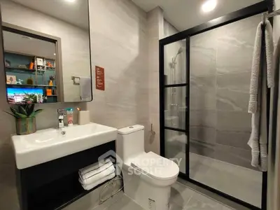 Modern bathroom with sleek shower and elegant fixtures in a contemporary home.
