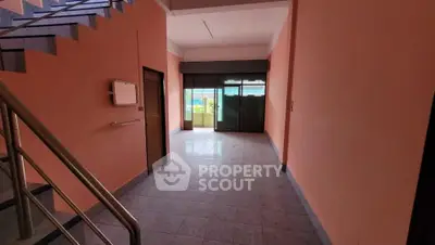 Spacious interior with large windows and tiled flooring, ideal for versatile use.