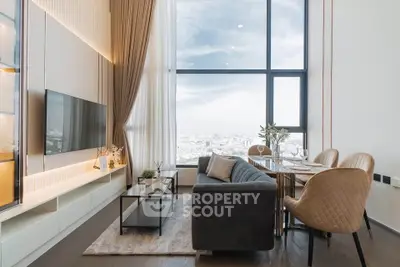 Luxurious high-rise living room with stunning city view, elegant decor, and modern furnishings.